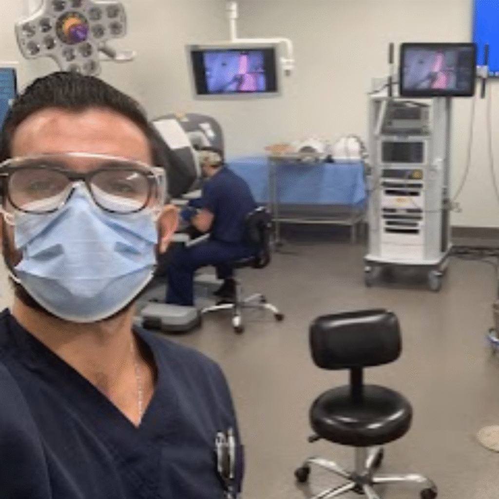 Dr. Rodrigo Alterio, a surgeon and co-author of The Home Doctor, in a modern operating room with a robotic surgery console.