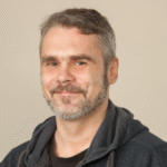 A friendly headshot of Claude Davis, chief editor of The Home Doctor and a respected survival expert.